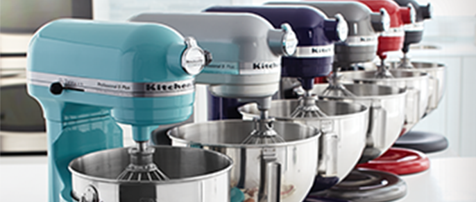 A row of KitchenAid stand mixers in a variety of colours.