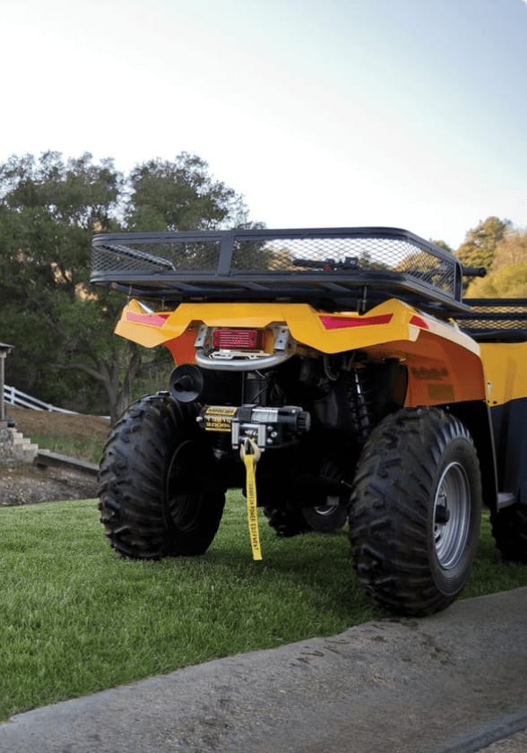 An ATV winch mounted to the rear of a yellow-and-black ATV.