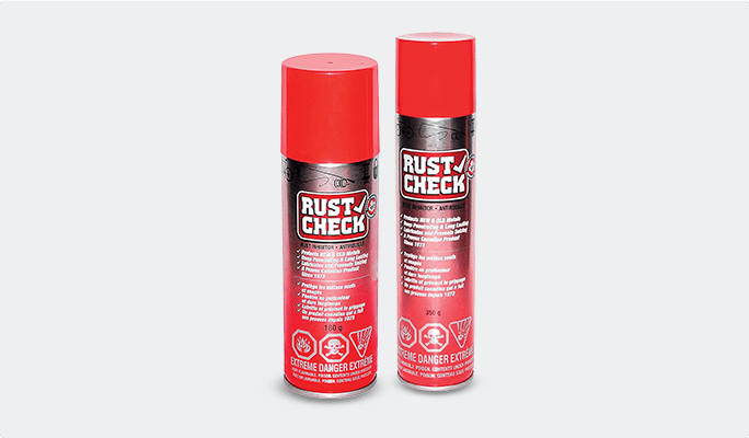 A 350-gram can of Rust Check spray and a 180-gram can of Rust Check Rust Inhibitor Spray set against a grey background.