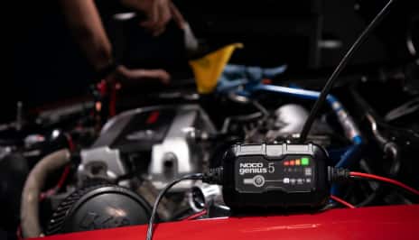 Battery charger in front hood of car