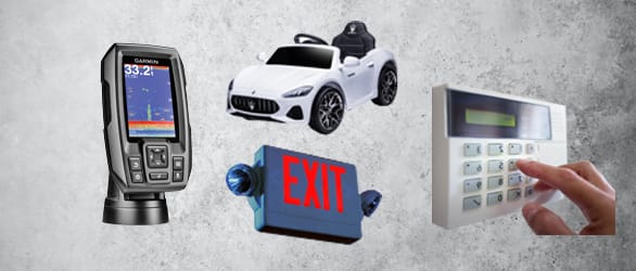 Collection of gadgets including exit sign, alarm system, and white toy truck