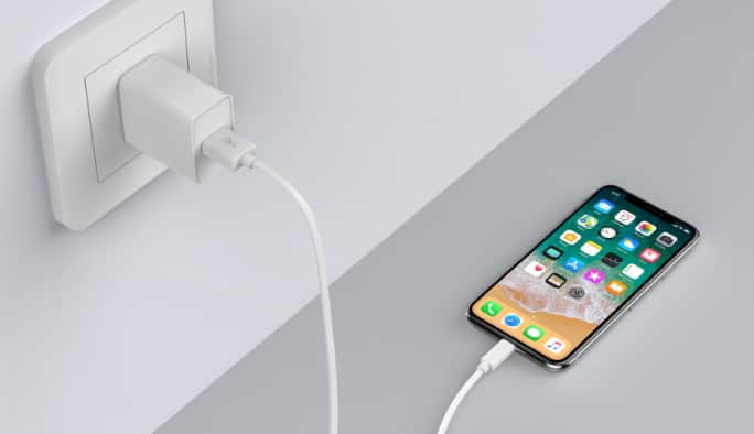 A white Bluehive 18W USB-PD Wall Charger charges a phone.