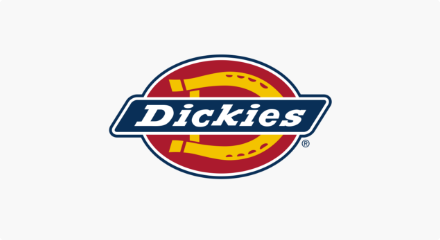 The Dickies logo: A white “Dickies” wordmark inside a blue rectangle, superimposed over a yellow horseshoe-shaped letter D inside a red oval.