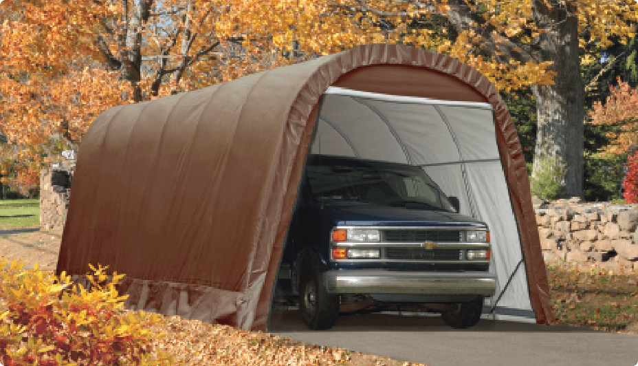 A truck parked inside a round style brown instant garage.
