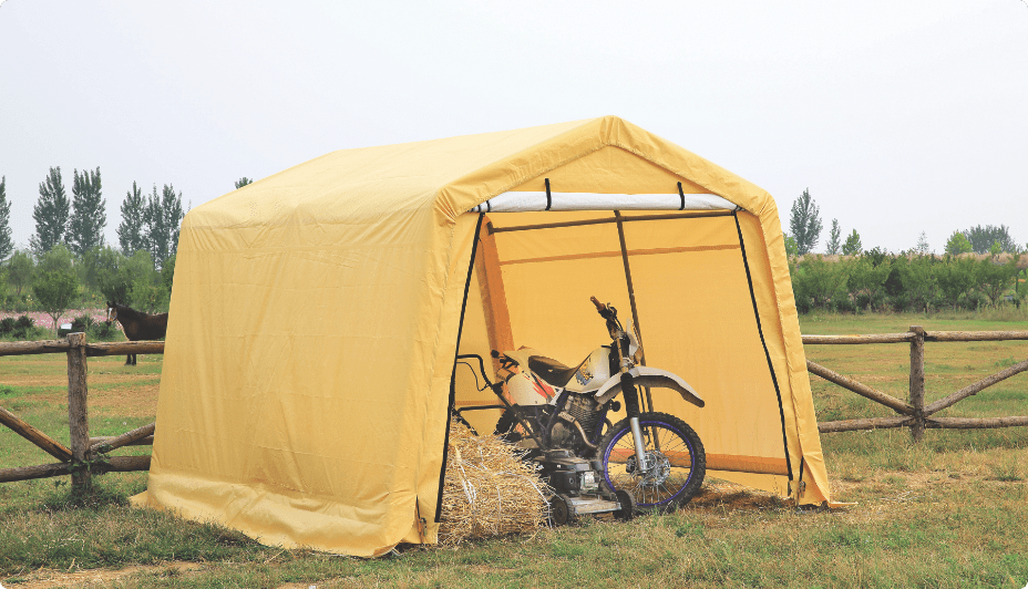  A dirt bike and push lawnmower inside a yellow storage shed.