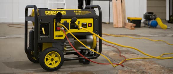 Black and yellow 3550W/4450W portable Champion generator with cables.