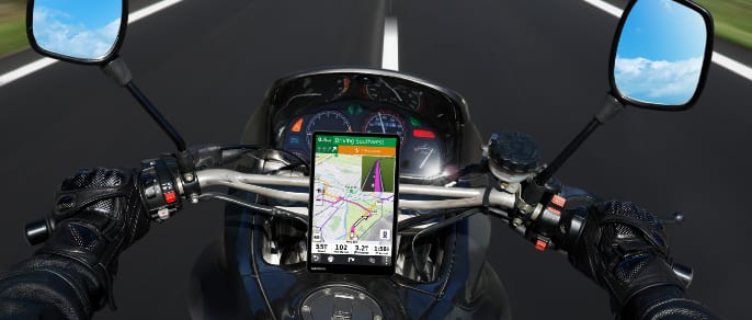 Close up of a motorcycle handlebar with two Boss Audio speakers.