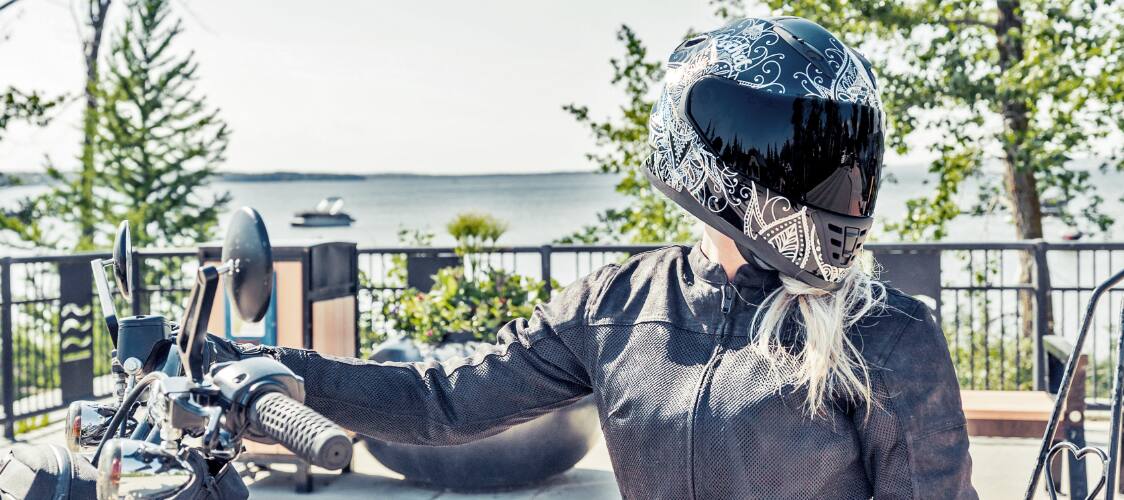Person on a black motorcycle wearing Joe Rocket apparel.