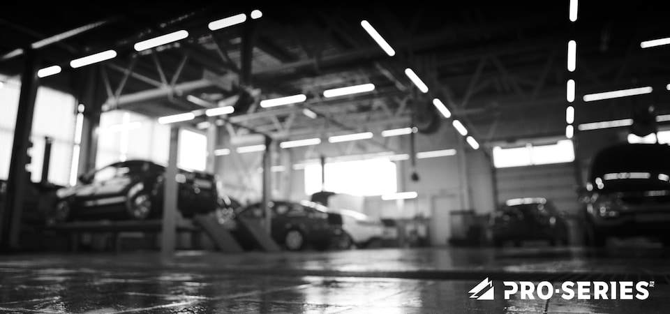 Cars on a hoist in a mechanic shop