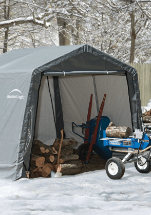 Portable shelter covering wood, wheelbarrow and other equipment.