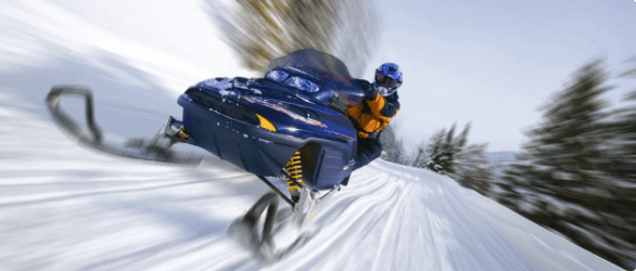 Person riding snowmobile. 