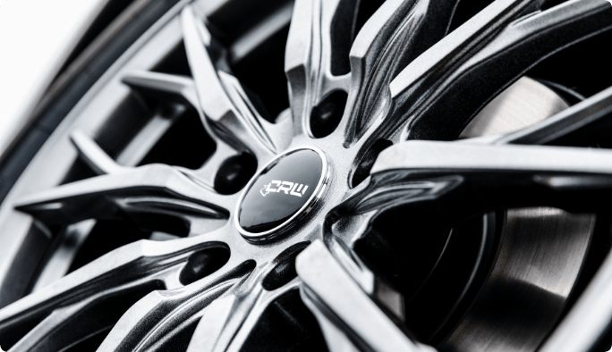 A close-up of a gunmetal-grey CRW GT1 Alloy Wheel. 