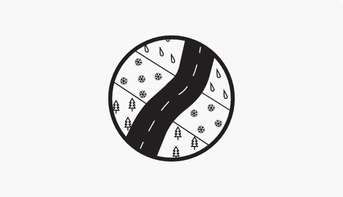 A circular icon featuring an illustration of a road curving through zones marked with pine trees, snowflakes, and raindrops.