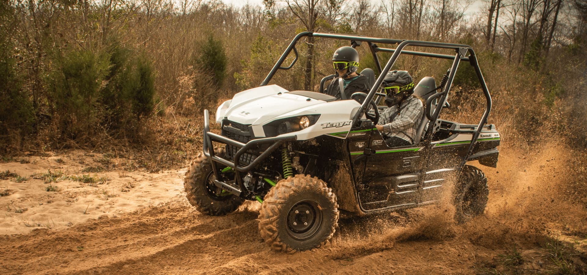 Two people riding their UTV in a muddy terrain. 