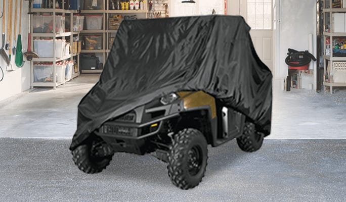 A UTV covered with a weatherproof cover. 