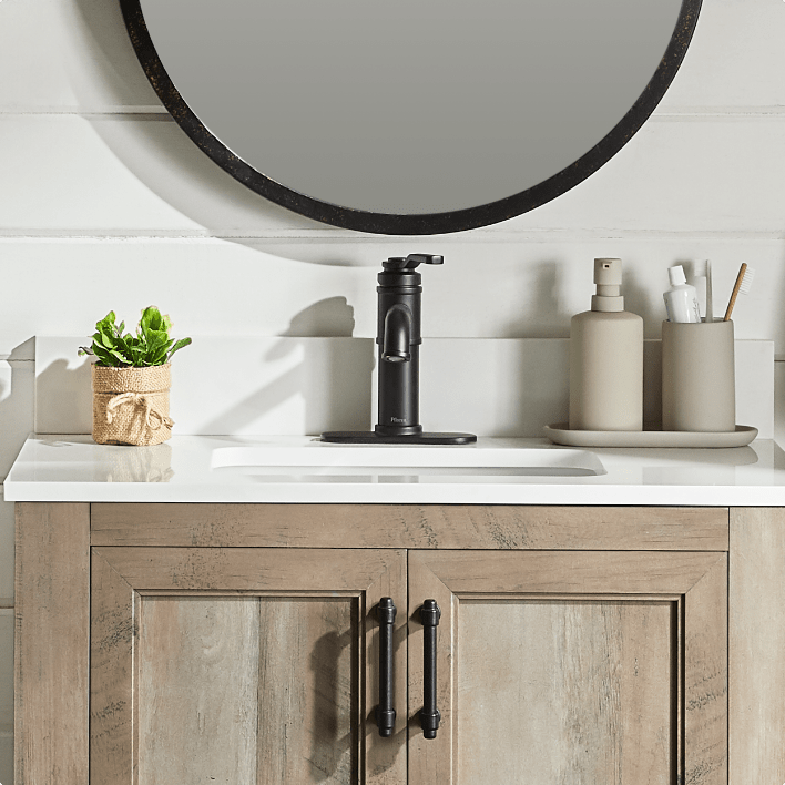A bathroom vanity with a stunning faucet.