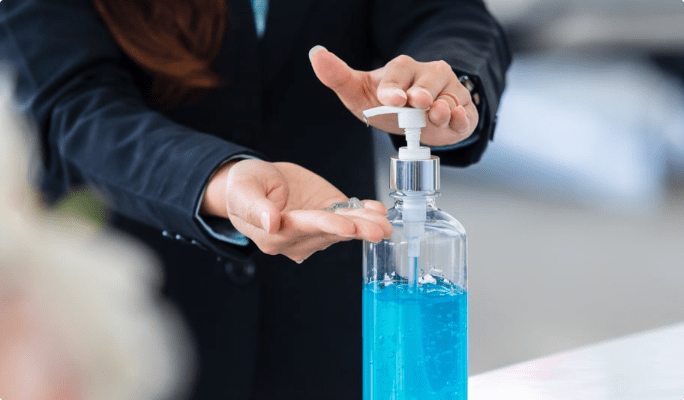 Woman dispenses hand sanitizer from a pump bottle.