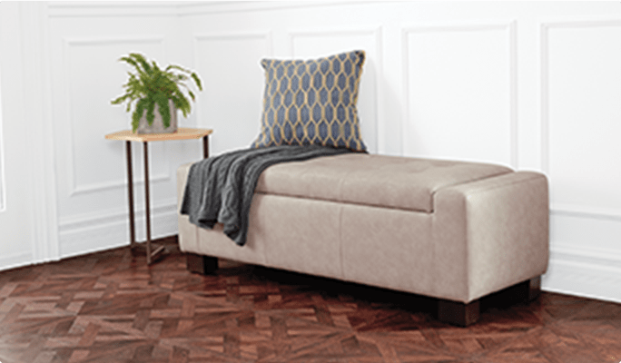 CANVAS Hexagon Side Table and Louisa Ottoman with Storage in a bedroom.
