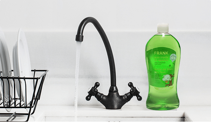 A bottle of green dish soap on a kitchen counter.