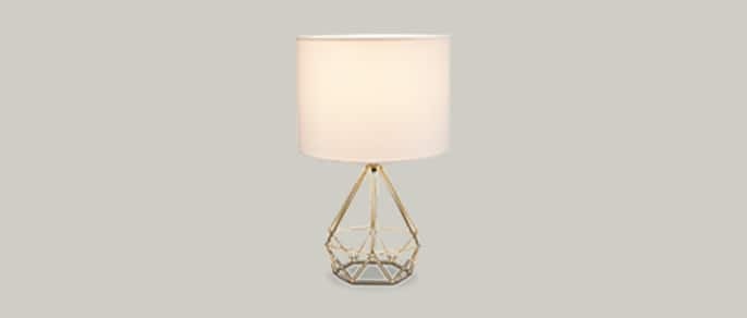 CANVAS Elita geo table lamp with a white shade and gold base.