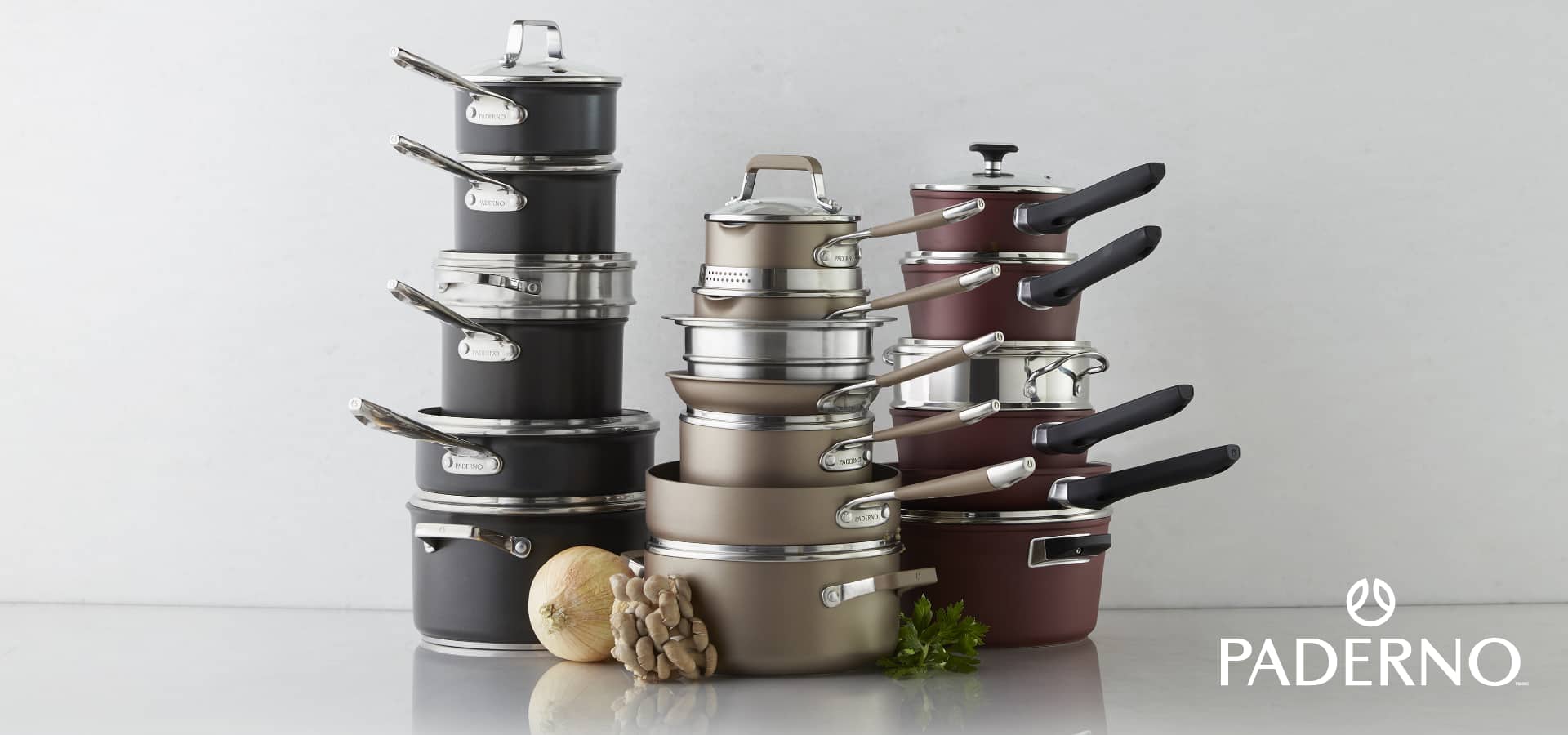 An assortment of pots and pans stacked up on top of each other.