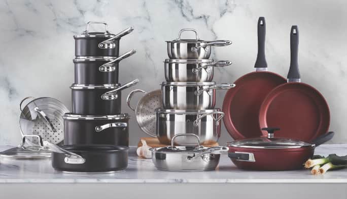 Pots, pans and various other cookware on a kitchen counter.