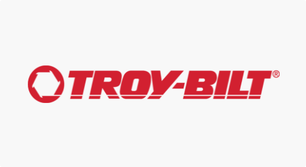 The Troy-Bilt logo: A white sprocket shape inside a red circle, to the left of a red “TROY-BILT” wordmark.
