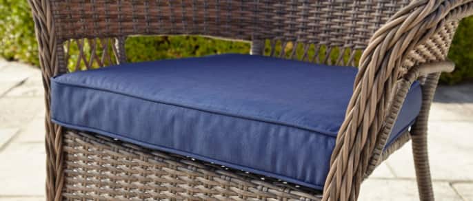 Close-up image of a blue cushion designed for an outdoor patio chair.