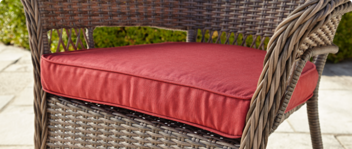 Close-up image of a red cushion designed for an outdoor patio chair.