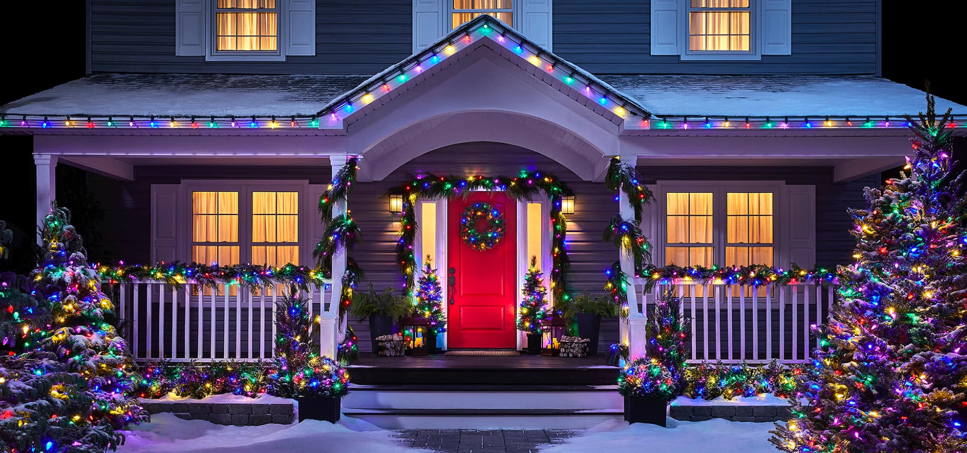 NOMA multi-coloured Christmas lights lit up outside a home