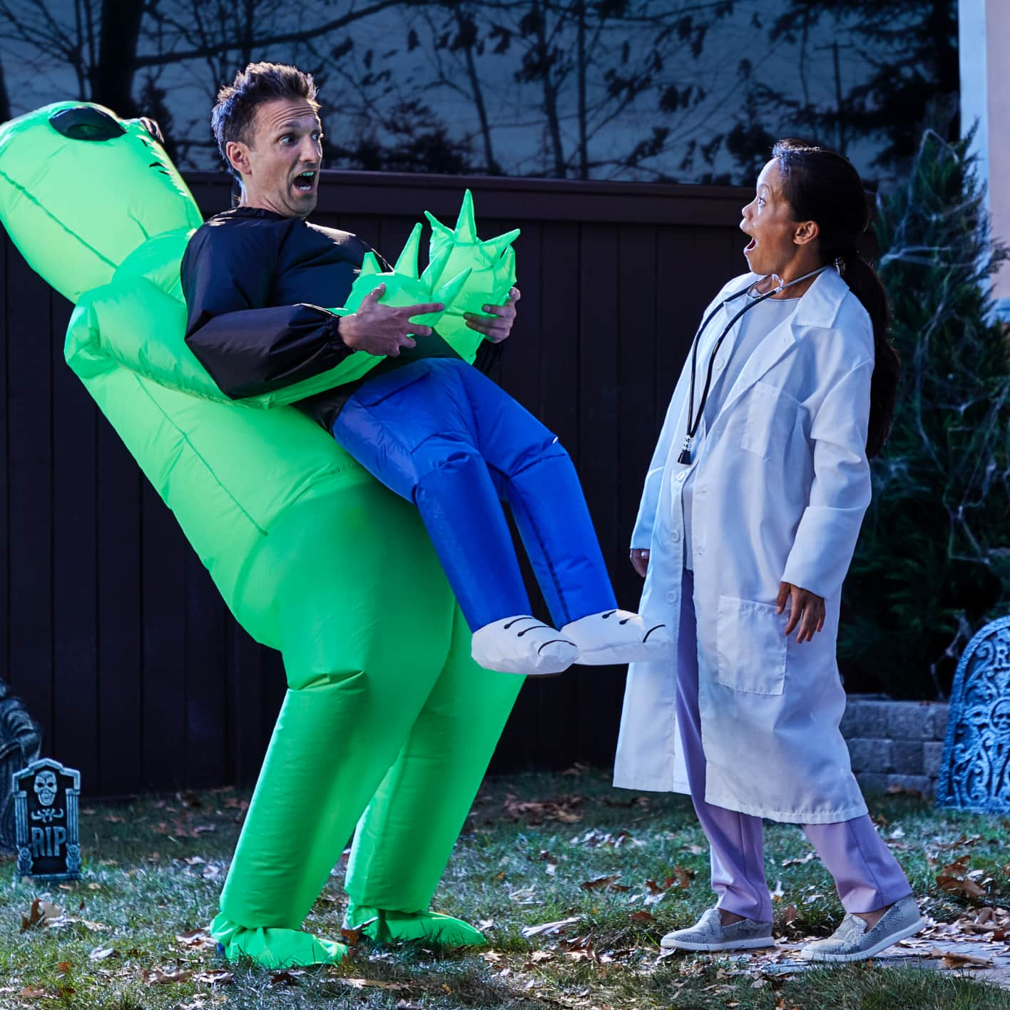 Man wearing a blow-up alien costume with a woman wearing a doctor’s costume