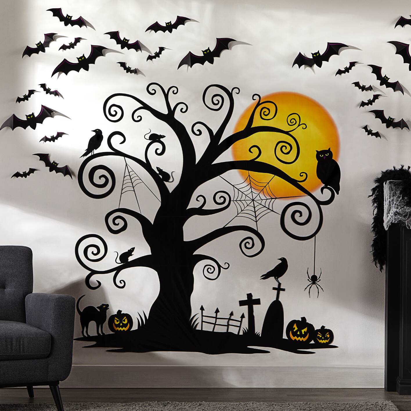 Wall decorated with Halloween sticker decals including a cemetery scene with a large tree, bats, owl and pumpkins.