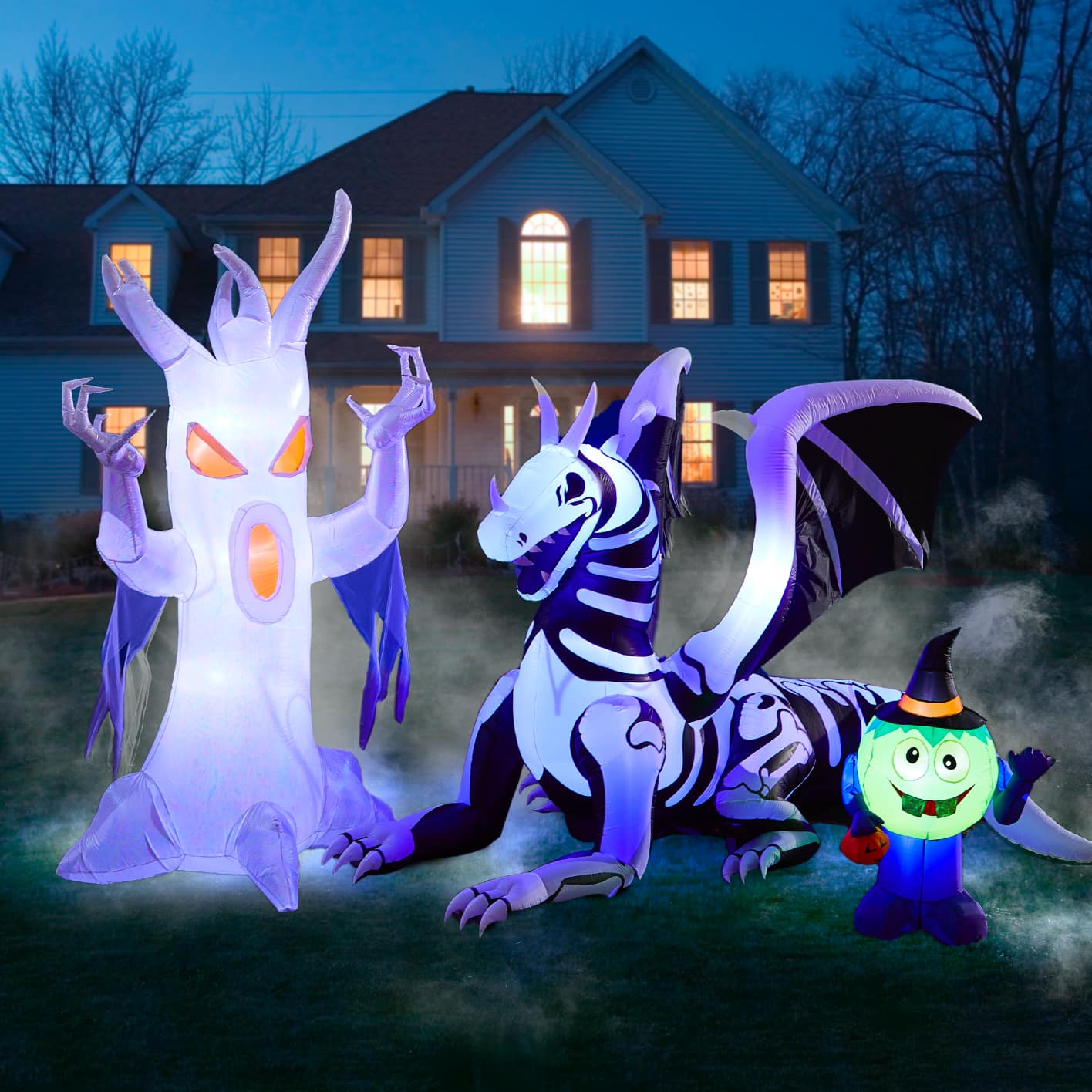 Ghost, dragon and ghoul character inflatables lit up on a front lawn.