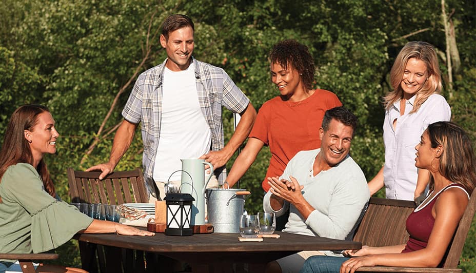 Group of people gathered around a table outdoors