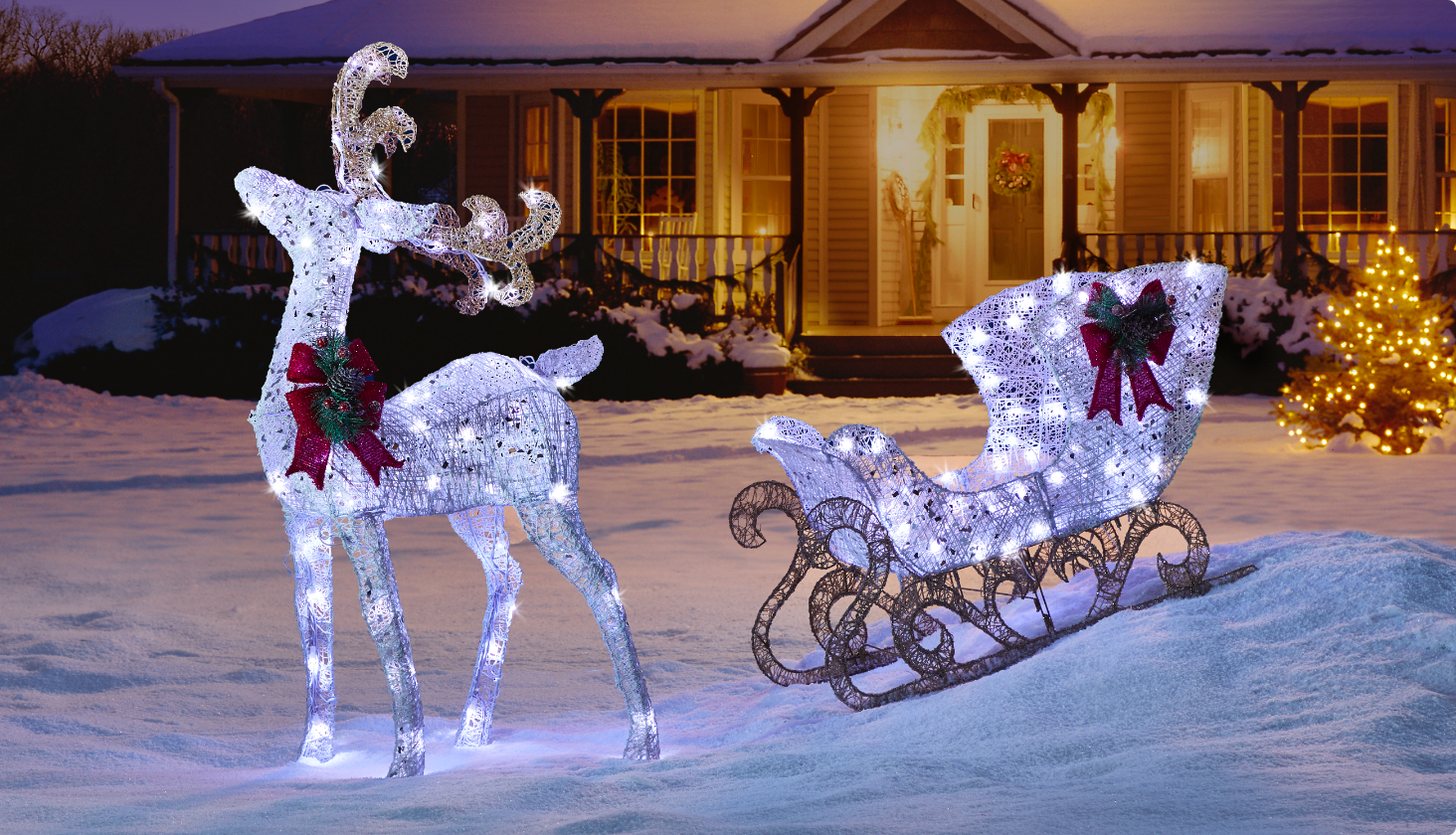 CANVAS LED 4-ft White Deer & Sleigh yard decoration on a front lawn of a house.
