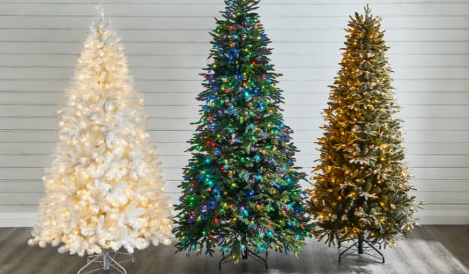 White Christmas tree, Full-size Christmas tree and a slim Christmas tree lit up on display.