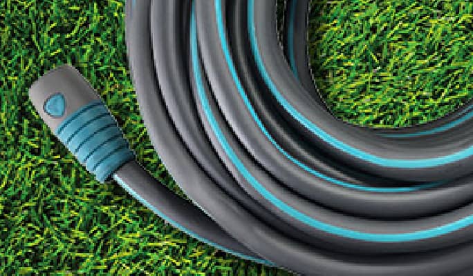 Grey and blue garden hose on the lawn