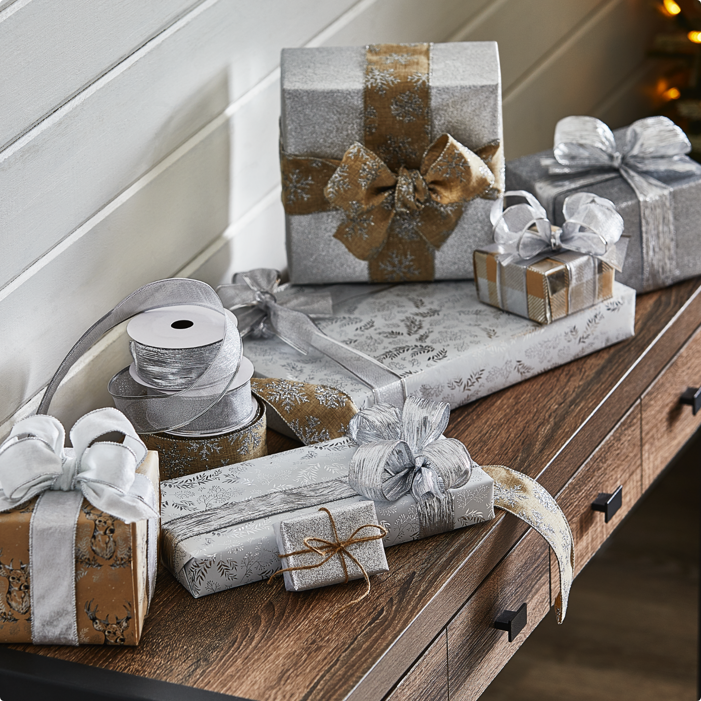 Gifts wrapped in the Canvas Silver wrapping collection on a table