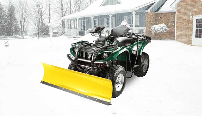 A yellow snow plow blade mounted to the front of a green ATV, set against a grey background. 