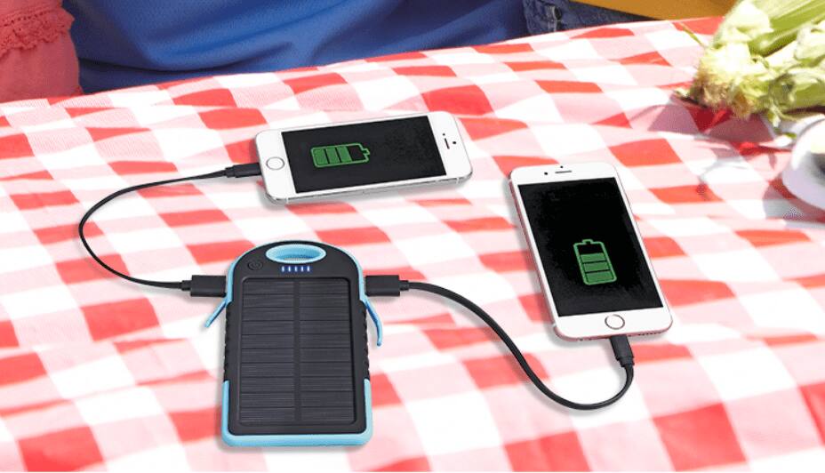 Two phones charging with solar battery charger