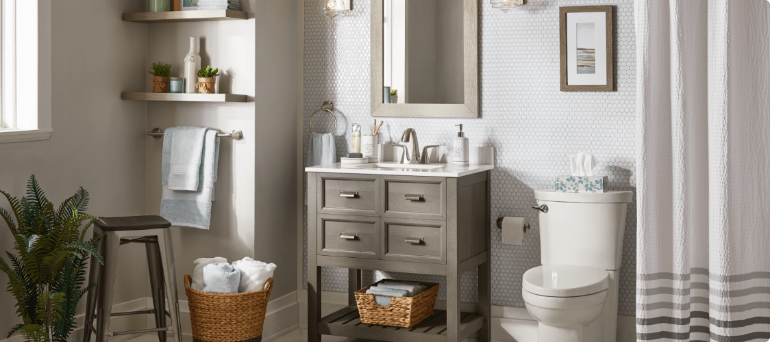 A modern bathroom scene including vanity, sink, toilet and cabinet.