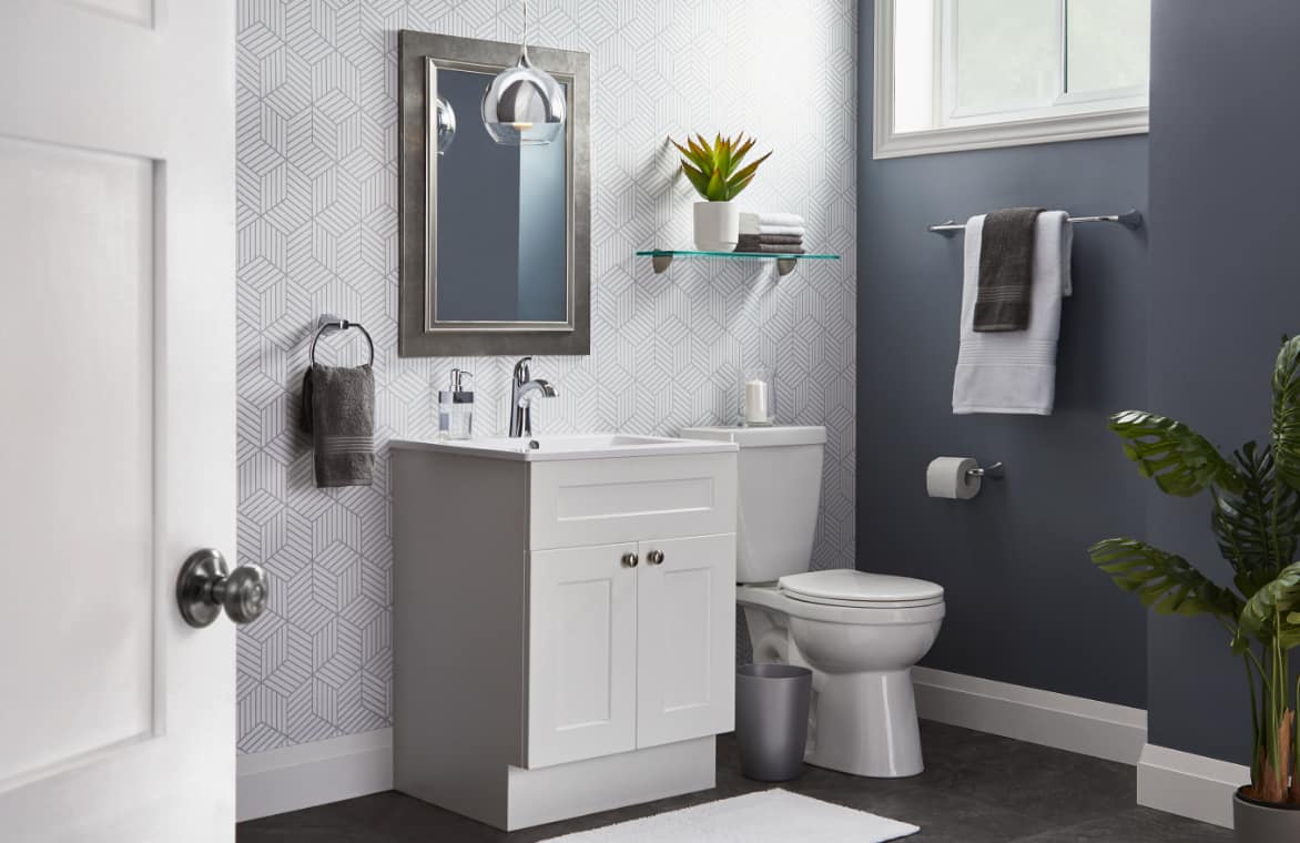 A single sink vanity with laminated finish in a neatly done bathroom.