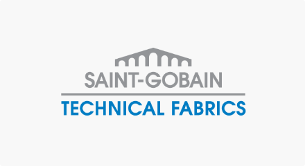 The Saint-Gobain Technical Fabrics logo: A stylized grey aqueduct-like structure above a grey “SAINT-GOBAIN” wordmark, all stacked over a blue “TECHNICAL FABRICS” wordmark