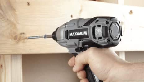 Person driving screw into a wooden panel with MAXIMUM drill/driver. 