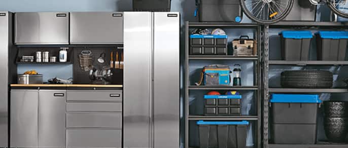 Maximum stainless series tall cabinet, two black storage racks with black storage bins with blue lids, bike hanging on garage ceiling rack.