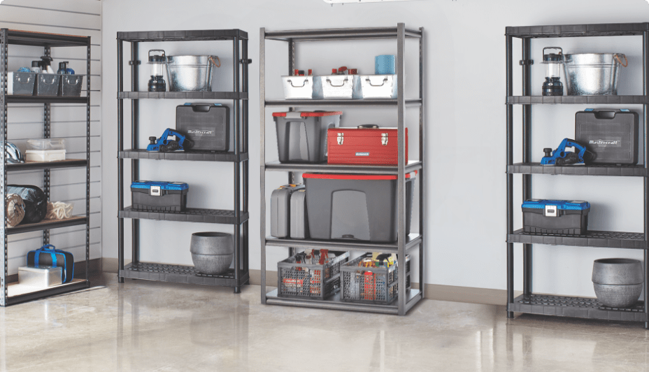 Neatly organized storage bins and tool boxes sit on four storage shelves inside a tidy garage.