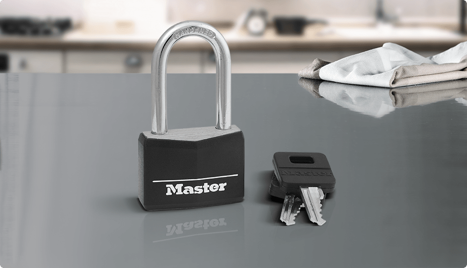 A black 40-mm Master Lock Vinyl-Covered Body Padlock with a long shackle and its matching keys on a white background.