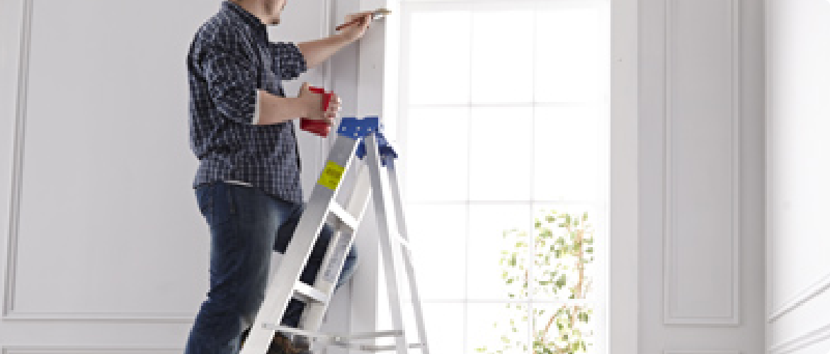  Man painting on a ladder