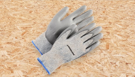 A pair of working gloves on a table. 