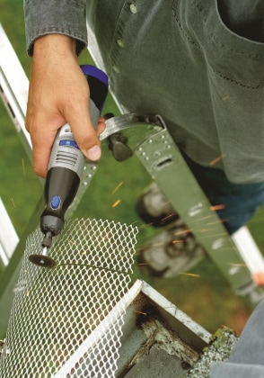 Person sawing through metal with a rotary tool